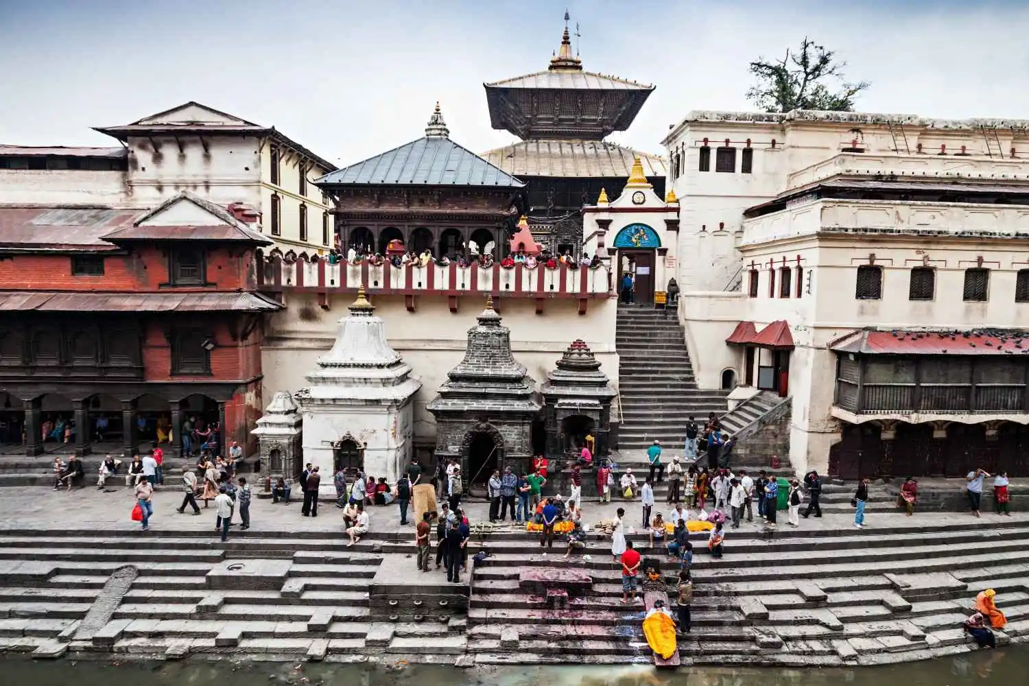 Pilgrims and visitors at Pashupatinath Temple in Kathmandu, Nepal, performing rituals and darshan on the banks of the Bagmati River